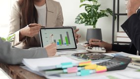 Financial experts collaborating over digital tablet and calculator, analyzing charts and data during strategic business meeting in modern office workspace - Powered by Shutterstock - Get 15% off with code: PIKWIZARD15