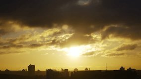 Sunrise under dark cumulus clouds with clouds and silhouettes of houses in big city. Background landscape of aesthetic morning in metropolis. - Powered by Shutterstock - Get 15% off with code: PIKWIZARD15