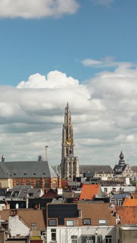 Vertical timelapse of Cathedral of Our Lady above the Antwerp skyline with moving clouds