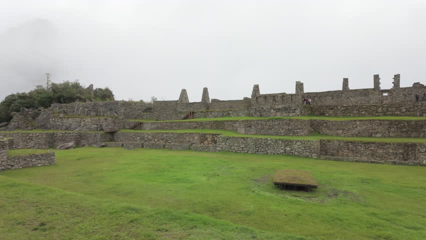 Slow motion video of Inca stone structures inside Machu Picchu, showing ancient walls and architecture in Peru