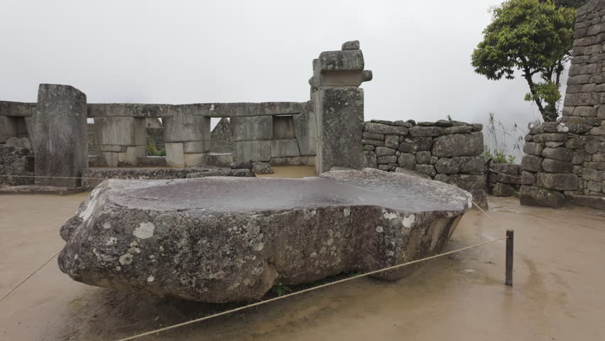 Slow motion video of Inca stone structures inside Machu Picchu, showing ancient walls and architecture in Peru
