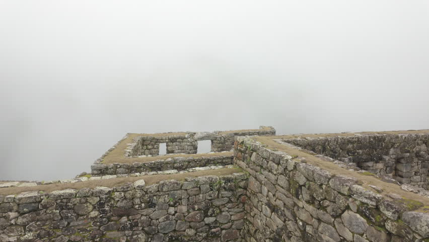 Slow motion video of Inca stone structures inside Machu Picchu, showing ancient walls and architecture in Peru