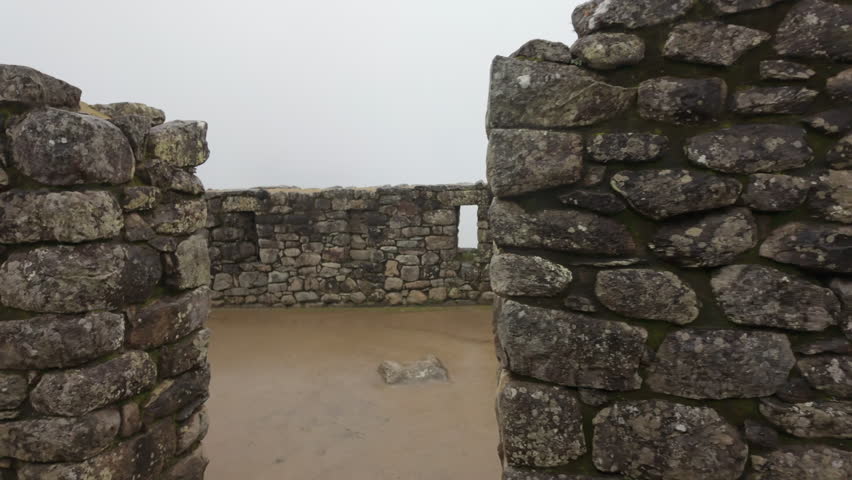 Slow motion video of Inca stone structures inside Machu Picchu, showing ancient walls and architecture in Peru