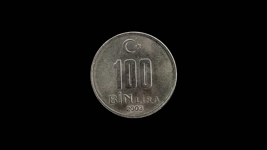 Turkish 100 Bin Lira coin from 2003 rotating against a pure black background with copy space