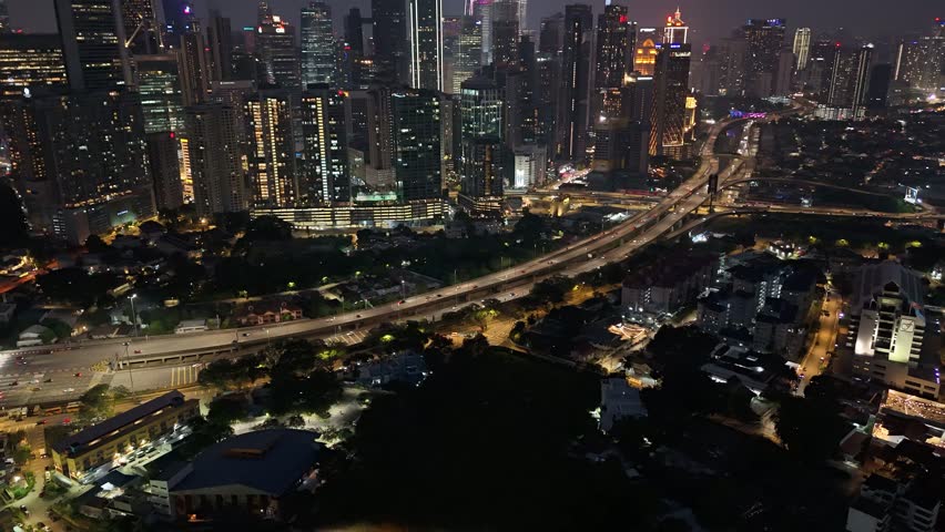 Kuala Lumpur city skyline at night with illuminated skyscrapers and highways
