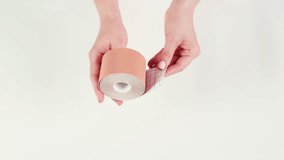 Kinesiology medical taping, doctor Physical therapist applying elastic surgical tape to patient body, treating injured knee young athlete.Post traumatic rehabilitation, sport physical therapy recovery - Powered by Shutterstock - Get 15% off with code: PIKWIZARD15