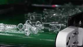 PET preforms. Making of Transparent PET plastic preforms move along automated conveyor belt in modern factory. Industrial production line concept for beverage bottles packaging automation recycling. - Powered by Shutterstock - Get 15% off with code: PIKWIZARD15