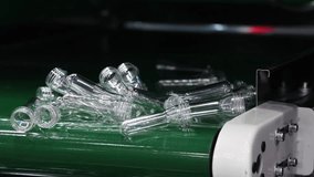 PET preforms. Making of Transparent PET plastic preforms move along automated conveyor belt in modern factory. Industrial production line concept for beverage bottles packaging automation recycling. - Powered by Shutterstock - Get 15% off with code: PIKWIZARD15