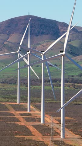 Vertical aerial telephoto zoom shot of wind turbines with hills near Port Augusta, South Australia