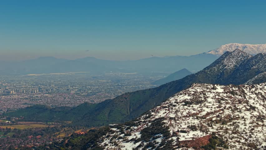 Drone Fly Santiago de Chile Snowed Hills, Panoramic Aerial, Skyline with Small plane at Manquehuito, Manquehue, El Carbon Mountain range