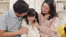 Young Asian family with daughter girls playing games at home Happy family-mother,father and daughter at home talking and smiling while spending time together - Powered by Shutterstock - Get 15% off with code: PIKWIZARD15