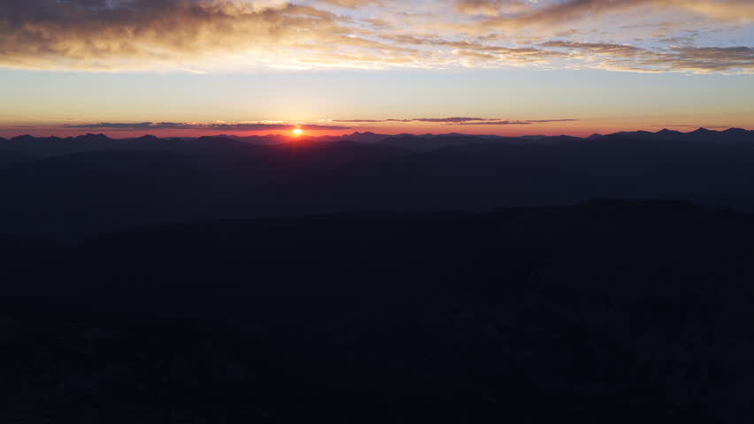 Rocky Mountains Colorado aerial drone sunrise on horizon low clouds early morning Mount of the Holy Cross Halo Ridge Notch Mountain Vail Minturn Sawatch Range Front Range Pikes Peak pan left motion