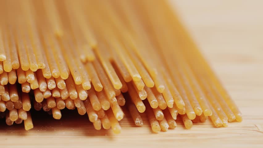 Wholegrain noodle background. Organic whole wheat spaghetti pasta, raw and dry.