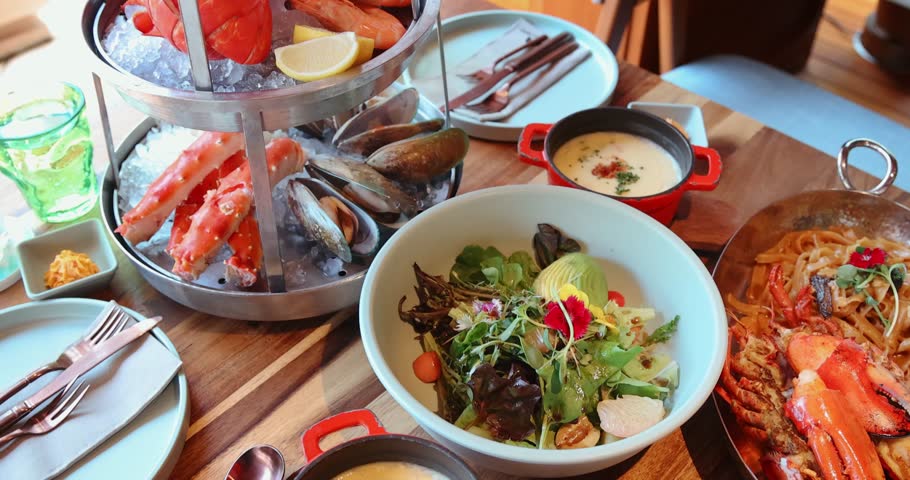 Gourmet seafood platter with crab, mussels, shrimp, paired with fresh salad in elegant restaurant setting. Captures luxury dining experience, perfect for culinary themes.