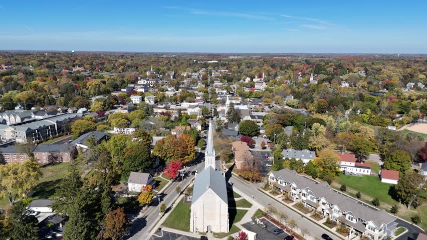 Slow cinematic aerial view of downtown Cedarburg WI featuring the steeple of St. Francis Borgia - South Church