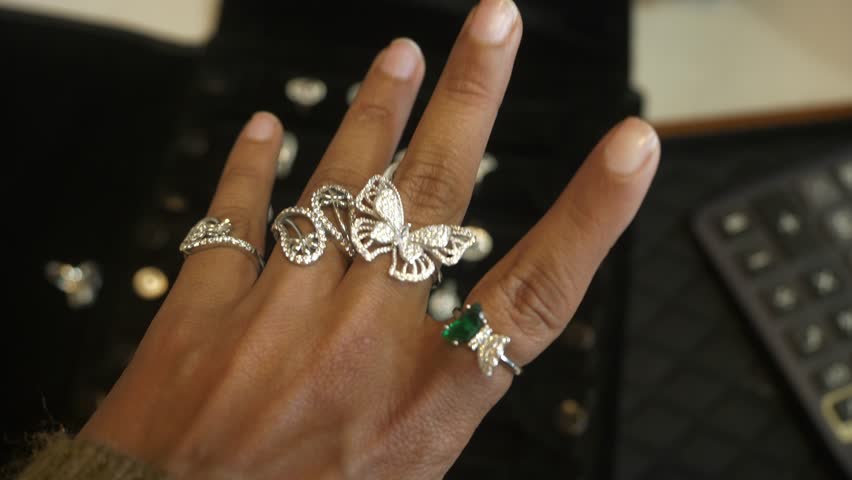 Designer and trendy silver finger rings on hand studded with lab grown diamonds, Closeup