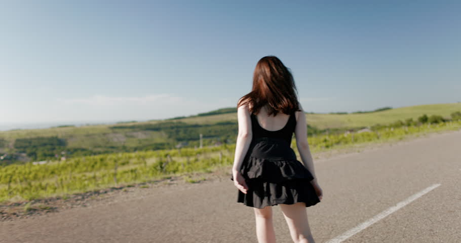 Beautiful woman riding on roller skates in sunny summer day