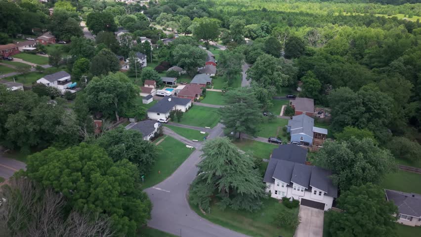 Middle Class Homes In A Suburban Neighborhood Surrounded By Trees In Nashville, Tennessee. Aerial Flyover.