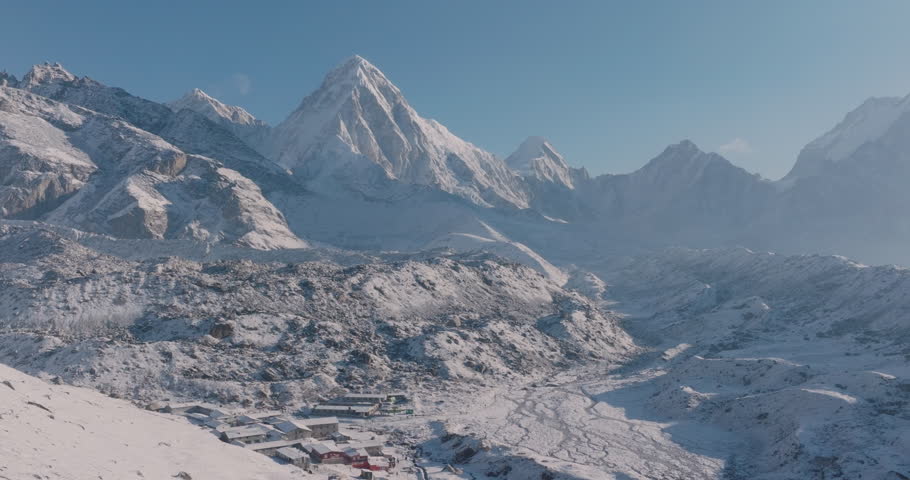 Drone shot of Everest Base Camp trek in Khumbu, Nepal. Tourists enjoy snowy landscapes and highland weather as Lobuche Sherpa village rests beneath Pumori and Lhotse peaks in the majestic Himalayas