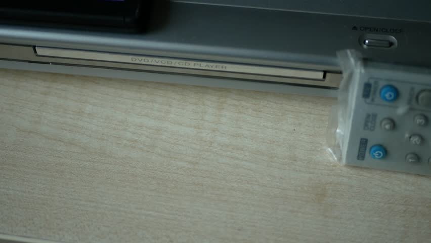 A Person Loading an Optical Disc