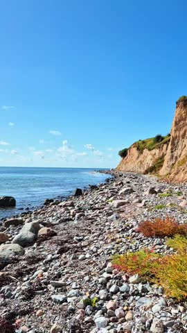 Stunning and Beautiful Coastal Landscape Featuring a Rocky Shoreline and a Clear Blue Sky