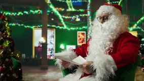 Senescent man playing Santa Claus role opening letter received from kids asking for presents. Senior citizen wearing Santa costume in Christmas ornate room reading letters from children, camera A - Powered by Shutterstock - Get 15% off with code: PIKWIZARD15
