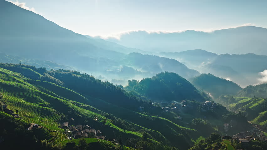 Summer scenery of Longji Terraced Fields with village at sunrise in Guilin, Guangxi Province, China.