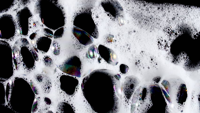 Texture of white soap foam with bubbles abstract background. Soap sud macro structure. Bathtup Soap Foam. Natural White Shampoo Bubbles Motion.