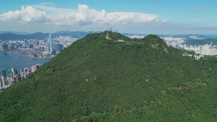 Footage from Victoria Peak showcasing panoramic views of Hong Kong city skyline, surrounding mountains, and urban landscape, highlighting iconic landmarks, natural scenery, and elevated perspectives.