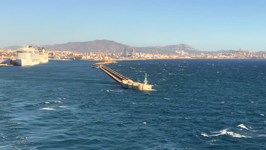 the rear view of a large ship leaving the port of Marseille