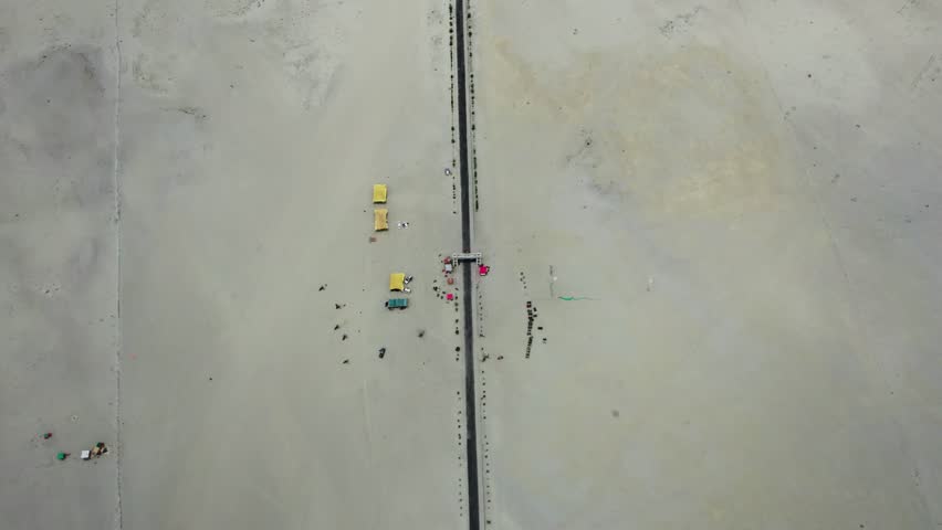 top-down shot of a straight road cutting across the barren Skardu cold desert. Skardu, Pakistan