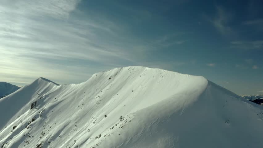 Majestic Winter Mountain Peak Snow Covered Ridge Aerial View Sky Blue Landscape Cold Wilderness Nature Scenery Snowdrift