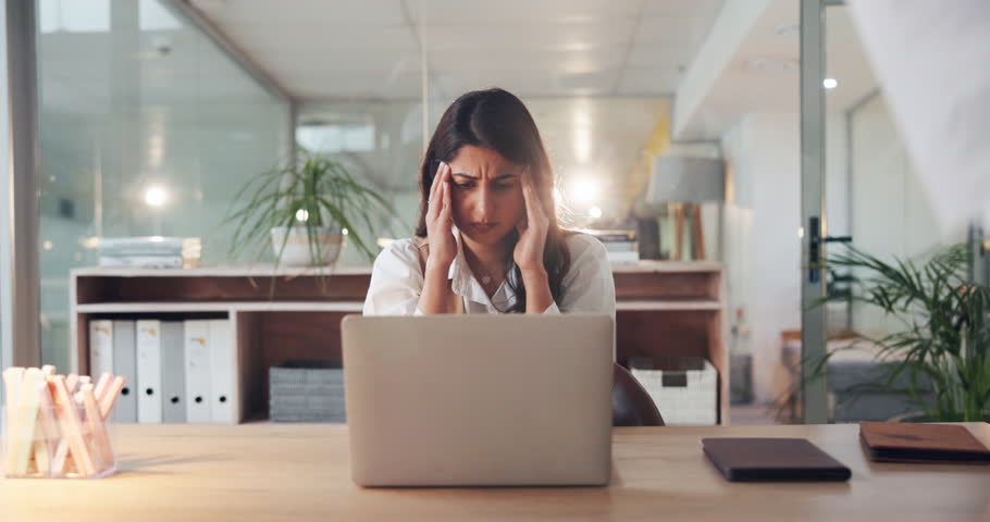 Woman, headache and chaos at office with paper falling, stress or overwhelmed with financial crisis. Person, accountant and migraine with laptop, pain or frustrated with paperwork for audit at agency