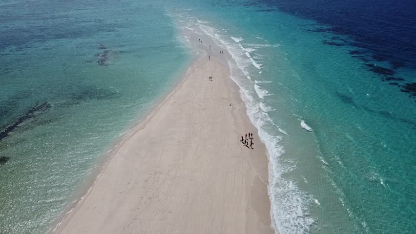 Aerial drone footage of Nakupenda, the disappearing sandbank island in Zanzibar, surrounded by turquoise waters of the Indian Ocean. Unique tidal island with white sand and no vegetation
