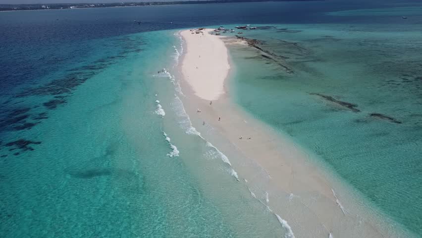 Aerial drone footage of Nakupenda, the disappearing sandbank island in Zanzibar, surrounded by turquoise waters of the Indian Ocean. Unique tidal island with white sand and no vegetation