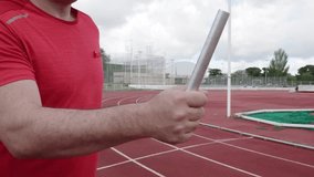 Runner passing a baton in a relay race inside a stadium - Powered by Shutterstock - Get 15% off with code: PIKWIZARD15