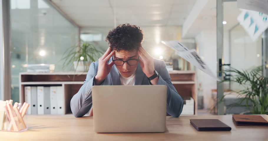 Businessman, stress and laptop with documents in air for overworked, pressure or anxiety in office. Frustrated man, employee or overwhelmed with headache, computer or paperwork for busy work or chaos
