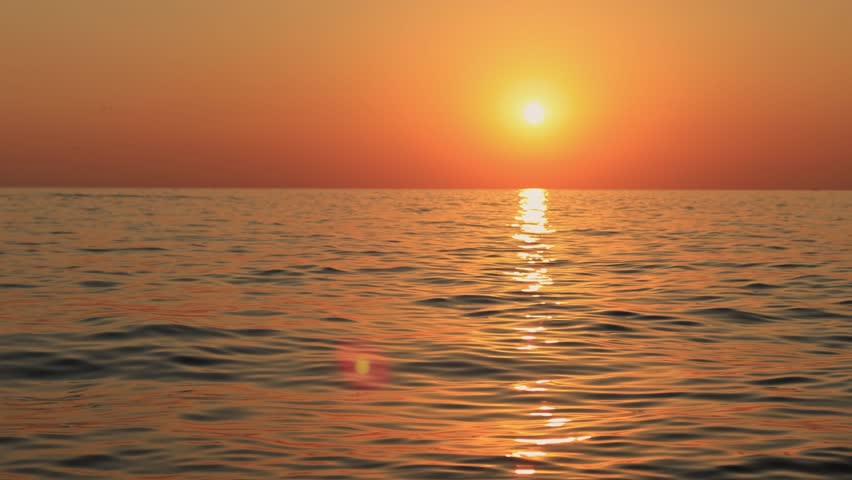 The silhouette of a jet ski against the backdrop of a sea sunset.