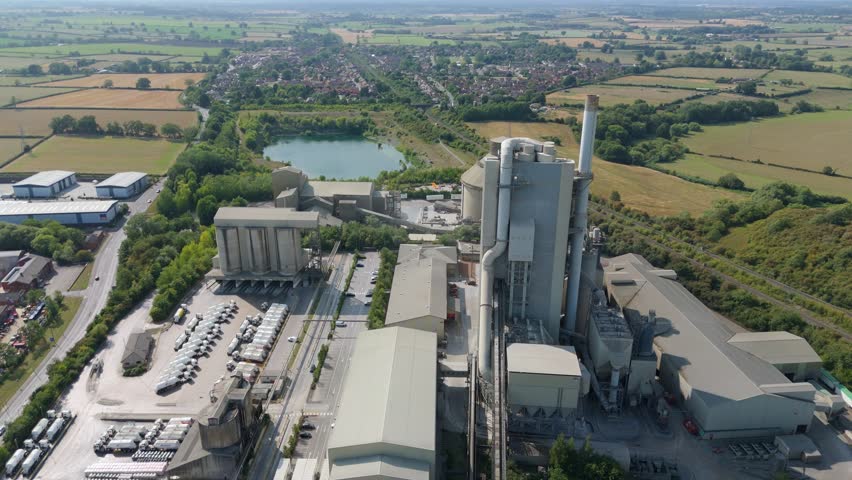 Industrial cement manufacturing factory and aggregates plant aerial drone view in Rugby England UK during bright summer weather