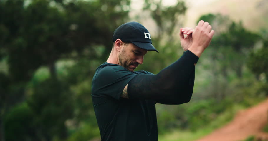 Man, trail runner and stretching for warm up in forest, exercise and ready for marathon training. Person, athlete and fitness routine with preparation for workout, outdoor and nature in Argentina