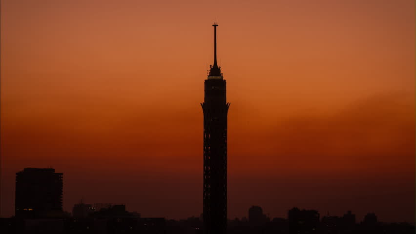 The sun is rising behind Cairo Tower in Egypt