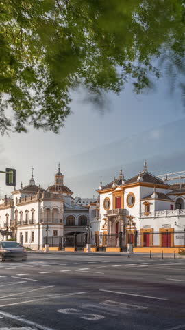 Plaza de Toros de la Real Maestranza de Caballeria de Sevilla timelapse hyperlapse. Historic bullring in Seville, Spain, known for its bullfighting festivals. Traffic passing in front of its facade
