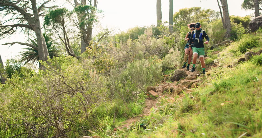 Running, hiking and travel with couple in nature for training, fitness adventure and health journey. Explore, environment and tourist with people on stone path for exercise, vacation and trekking