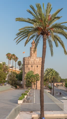 Torre del Oro timelapse hyperlapse, a dodecagonal military watchtower in Seville, Spain. Built by the Almohads to control Guadalquivir River access. Historic landmark at evening before sunset