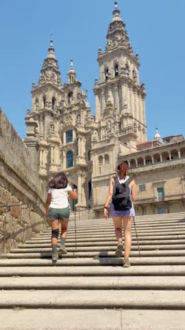 Two Friends Emotionally Embrace After Completing the 100km Camino de Santiago at Santiago Cathedral. Overcoming Physical and Mental Limits