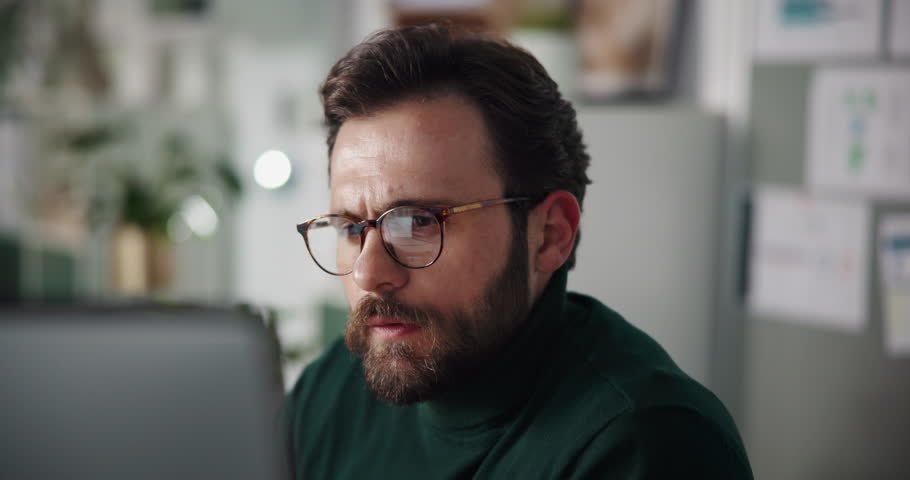 Business man, computer and serious in office for reading article, fast checking info and editing. Editor, person and technology at magazine agency for proofreading publication and source verification