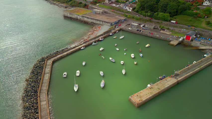 Wide ascending aerial video of Newcastle Harbour in County Down, Northern Ireland. Filmed in 4K, 60FPS and with Rec709 color.