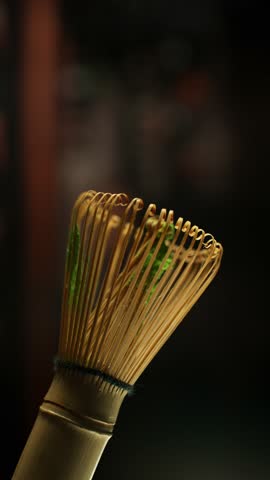 Super Slow Motion Detail Shot of Sprinkling Matcha Powder on Stirrer . Filmed on High Speed Cinematic Camera at 1000 FPS