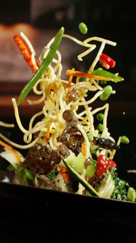 Super Slow Motion of Flying Asian Wok Ingredients . Filmed on High Speed Cinema Camera