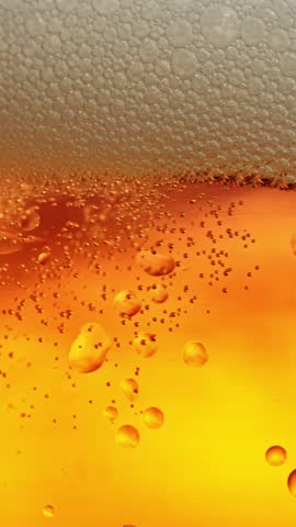 Super Slow Motion of Macro Shot of Pouring Beer Drink, Close-up. Filmed on High Speed Cinema Camera, 1000 fps.